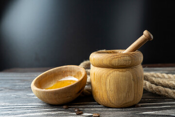 Golden honey on the stick and wooden jar. Aromatic nectar in a bowl.  on wooden background. Honey in a pot or jar on kitchen table. Sweet background. Selective focus. Healthy Food Concept.