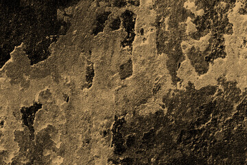 Dark brown color rugged stone wall surface for texture background