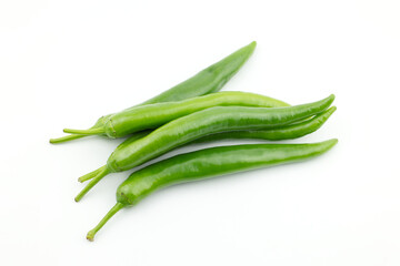 Pile of fresh raw ripe hot organic green chili peppers whole isolated on white background clipping path, top view