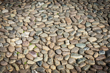 Close-up of a paving stone made of small cobblestones in Brescia downtown, Piazza della Loggia (Loggia square), Lombardy, Italy, southern Europe.