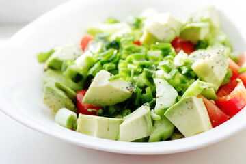 fresh salad with tomatoes and cucumbers and avocado