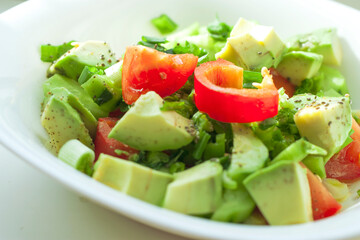 fresh salad with tomatoes and cucumbers and avocado
