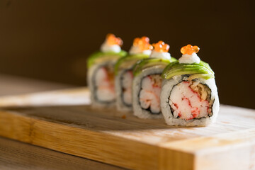 gunkan with raw fish on wooden cutting board, Japanese cuisine