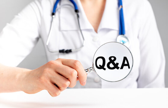 Doctor answers to patients questions about medical care. FAQ in health and medicine concept. Woman with stethoscope in lab coat holding magnifier with letters q a. High quality photo