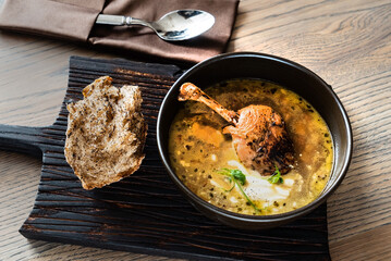 soup with duck on wooden board