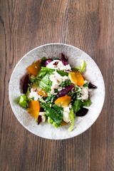 Healthy salad with persimmon