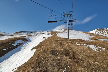 Ski lift at a ski resort with little snow - 499862028