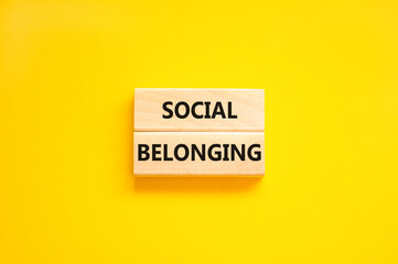 Social belonging symbol. Wooden blocks with concept words Social belonging on beautiful yellow background. Business political social belonging concept. Copy space.