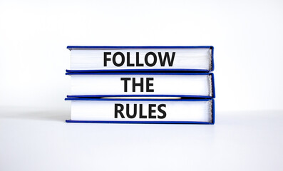 Follow the rules symbol. Concept words Follow the rules on books. Beautiful white table white background. Business and follow the rules concept. Copy space.