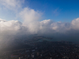 A magical flight in the clouds over the city. The sun's rays are beautifully reflected from the clouds. Above the sky. Fluffy clouds. shooting at high altitude.