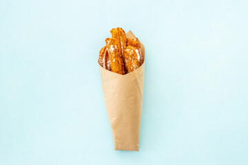 Churros street food dessert in paper bag