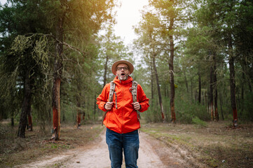 Portrait of a man with a hat in a forest.