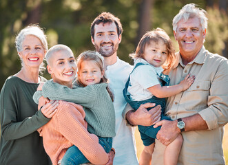 This is all of us. Shot of a multi-generational family posing together outdoors.