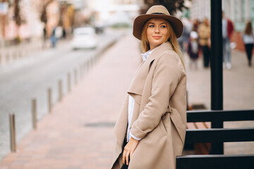 Woman in coat and hat outdoors