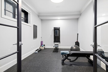 Simple Home Gym. Small room in basement with workout equipment.