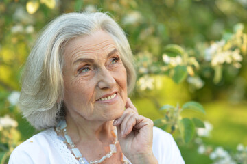 Portrait of senior beautiful woman in spring park