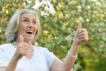 Portrait of happy senior beautiful woman in spring park