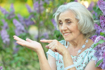 Portrait of happy senior beautiful woman in spring park