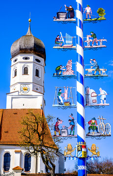 Andechs, Germany - April 14: typical bavarian maypole with old paintings in front of blue sky in Andechs on April 14, 2022