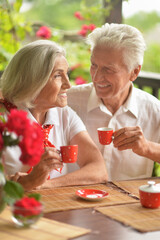Portrait of happy senior couple drinking coffee