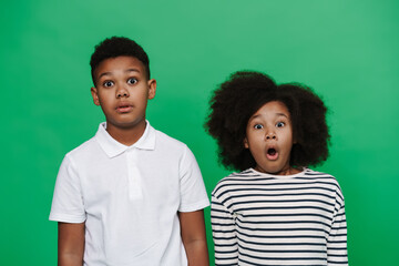 Black boy and girl expressing surprise together at camera