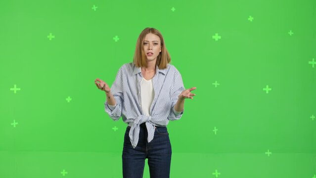 Sad upset dissatisfied irritated young woman say what is going on . Girl making face palm by hand posing against green screen background studio. Chroma key