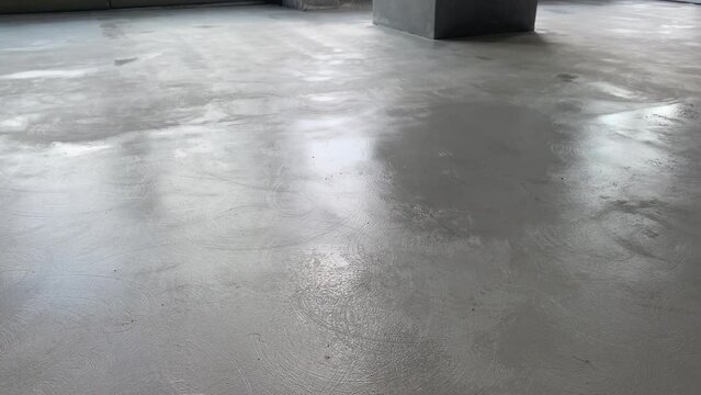 The process of priming the floor with a roller