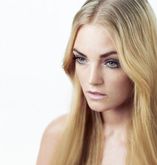 Naklejka premium Intense beauty. Studio shot of beautiful young woman looking away.