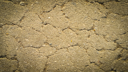 Crack on the asphaltic surface. Natural pattern on textured surface. Ruined of the walkway.
