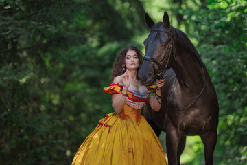 A young woman in a vintage yellow dress walks with a brown horse in a green park on a summer day