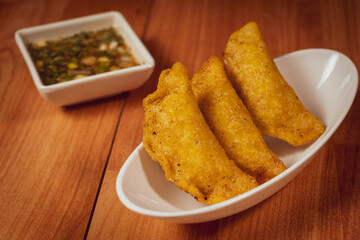 Colombian empanada with spicy sauce