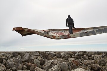 Photographer on broken bridge metal beam
