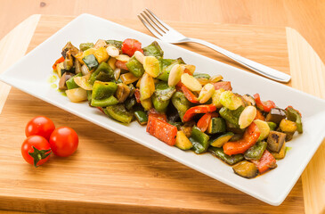Typical Spanish food, vegetable stew. Horizontal view of food on a white plate.