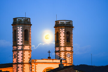 Full moon between church towers