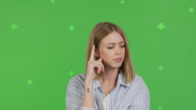 Close-up of thinking girl. Young pretty woman on green screen background, Chroma Key 4k video footage slow motion 60 fps