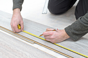 Fototapeta na wymiar installing new laminated wooden floor. copy space