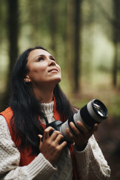 Woman taking pictures in the woods