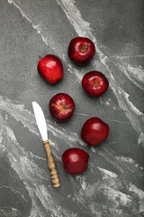 Fresh red apples. On a black stone background. Top view.