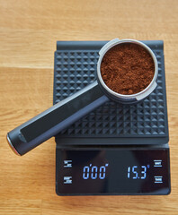 Horn with ground coffee lies on coffee scales