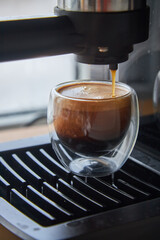 Making fresh coffee going out from a coffee espresso machine.