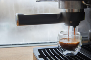 Making fresh coffee going out from a coffee espresso machine.