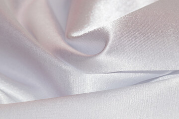 Close up of white draped textile material.