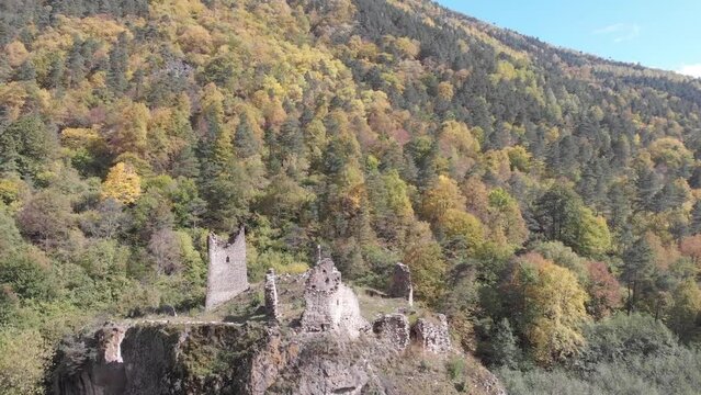 Flying between ancient towers of Egikal complex out of the river. Republic of Ingushetia. Caucasus mountains, Russia.