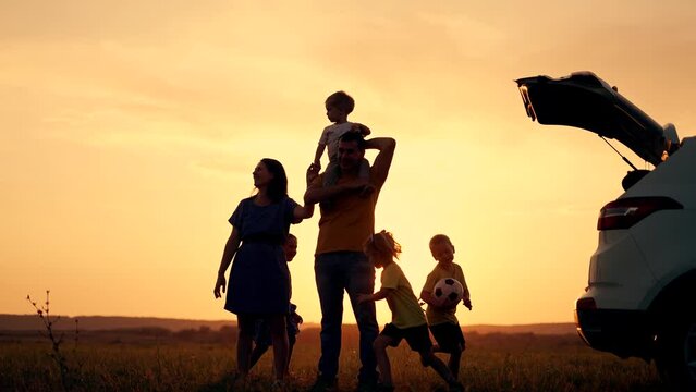Happy family travel by car.People are having fun on vacation at sunset.Father mother and children picnic in nature.Car travel concept. Children play in park.Happy family concept.Family vacation by car
