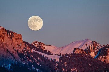 full moon over the snowy mountains © Raul