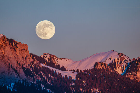 full moon over the snowy mountains