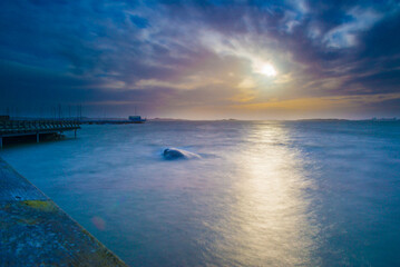 Fototapeta premium Long exposure photo of sunset over a small bay.