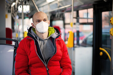 A man in a medical mask in public transport. The concept of the necessary precautions during a...