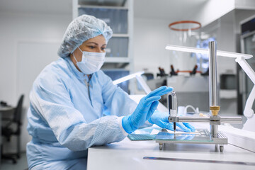 A female scientist takes measurements in the laboratory