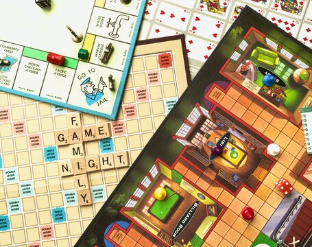 Family Game Night. Monopoly, Clue, Scrabble, and Sequence board games. Classic table games. Monopoly multi-player economics game. Clue murder mystery game. Scrabble is a word game.